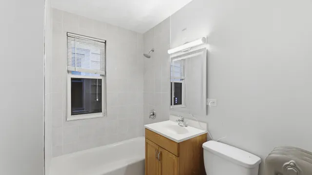 a view of a small space with wooden floor and a window