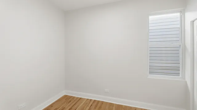 a view of a room with wooden floor and windows