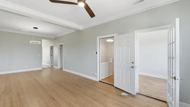 a kitchen with stainless steel appliances granite countertop a refrigerator a sink dishwasher a stove and white cabinets with wooden floor