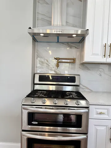 a view of an empty room with window and mirror