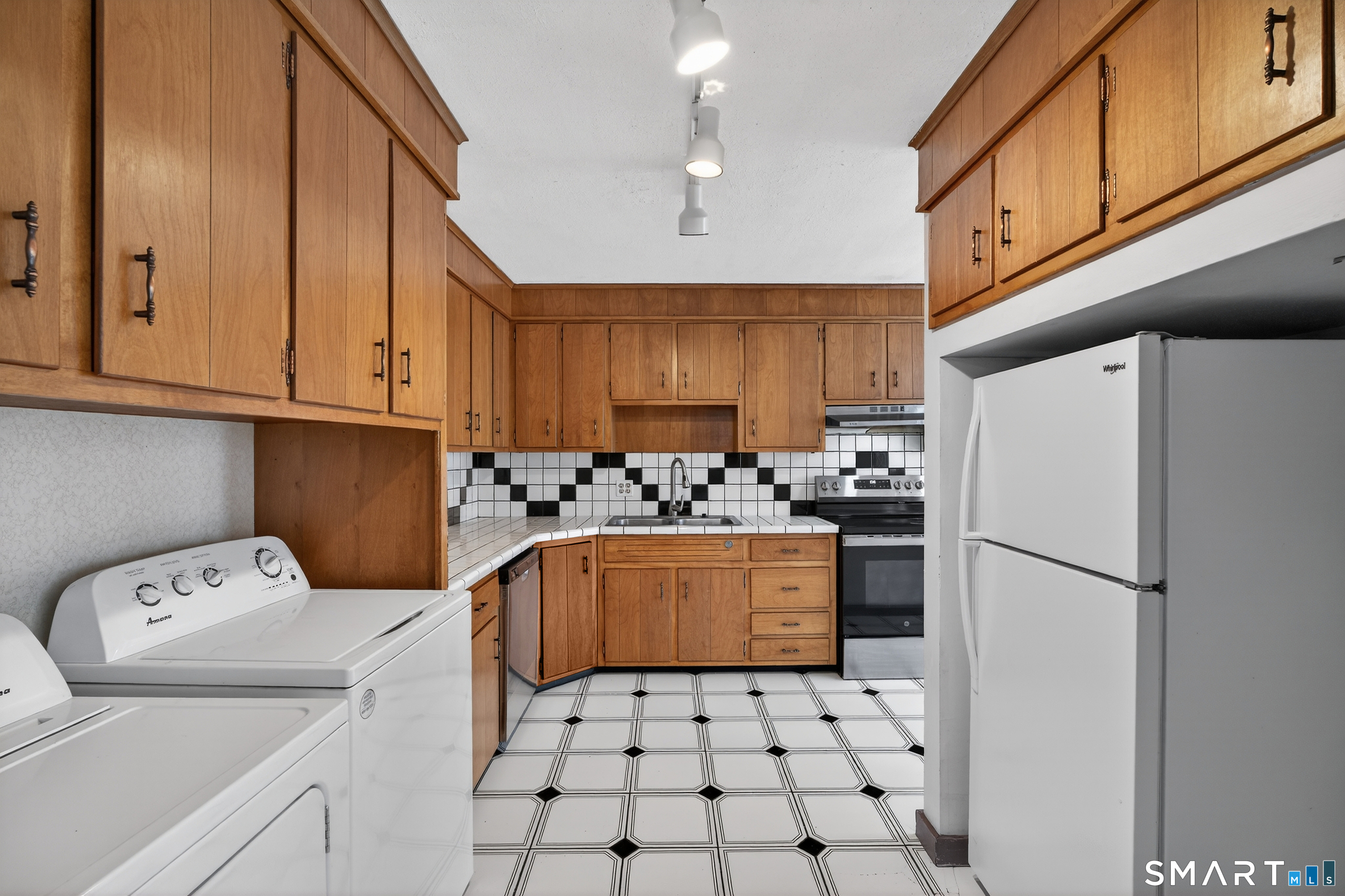 1553 Glasgo Road Griswold, CT 06351 - Photo 15 of 37 a kitchen with a refrigerator a stove top oven a sink and cabinets