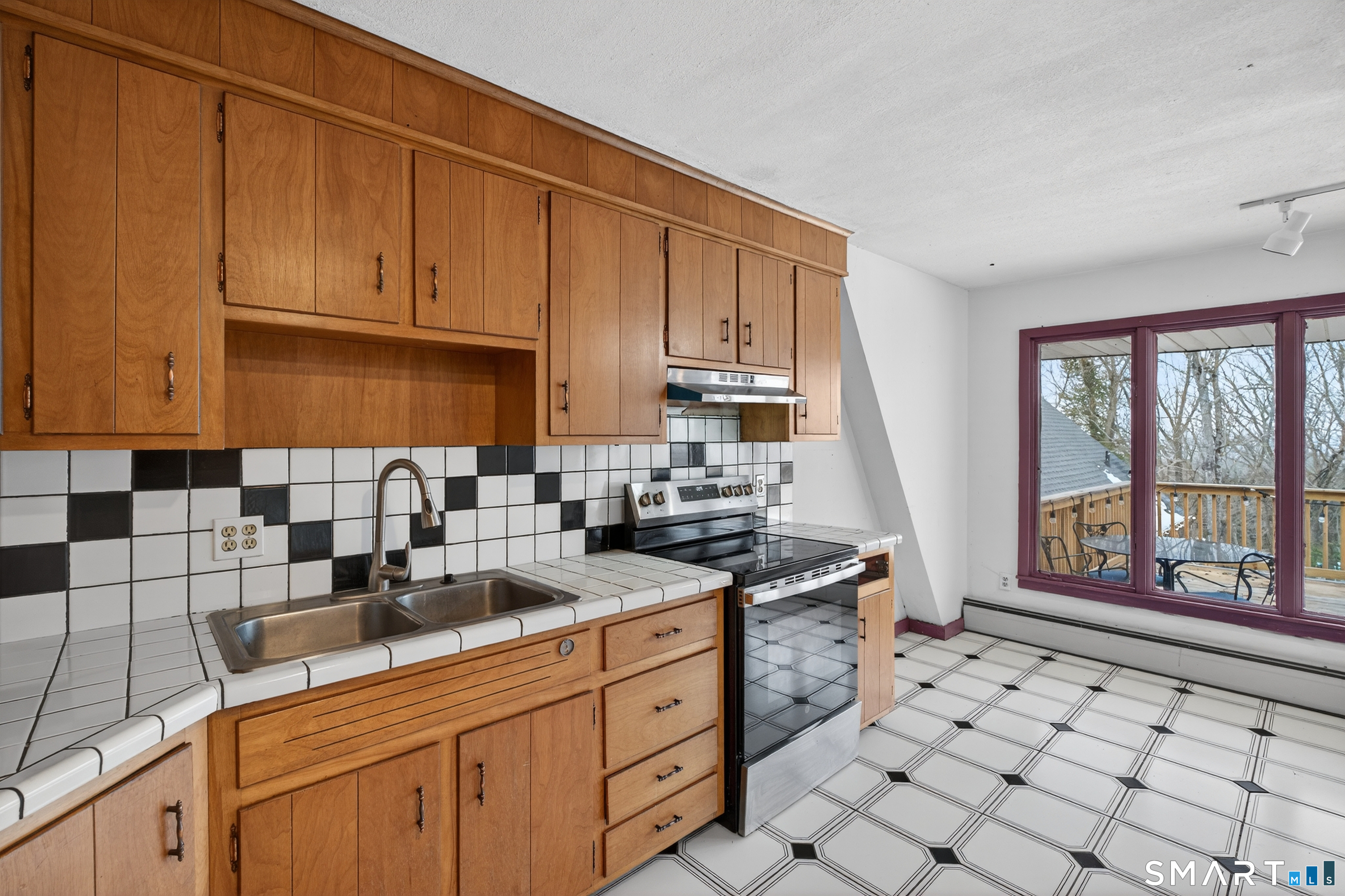 1553 Glasgo Road Griswold, CT 06351 - Photo 16 of 37 a kitchen with stainless steel appliances granite countertop a sink stove and cabinets