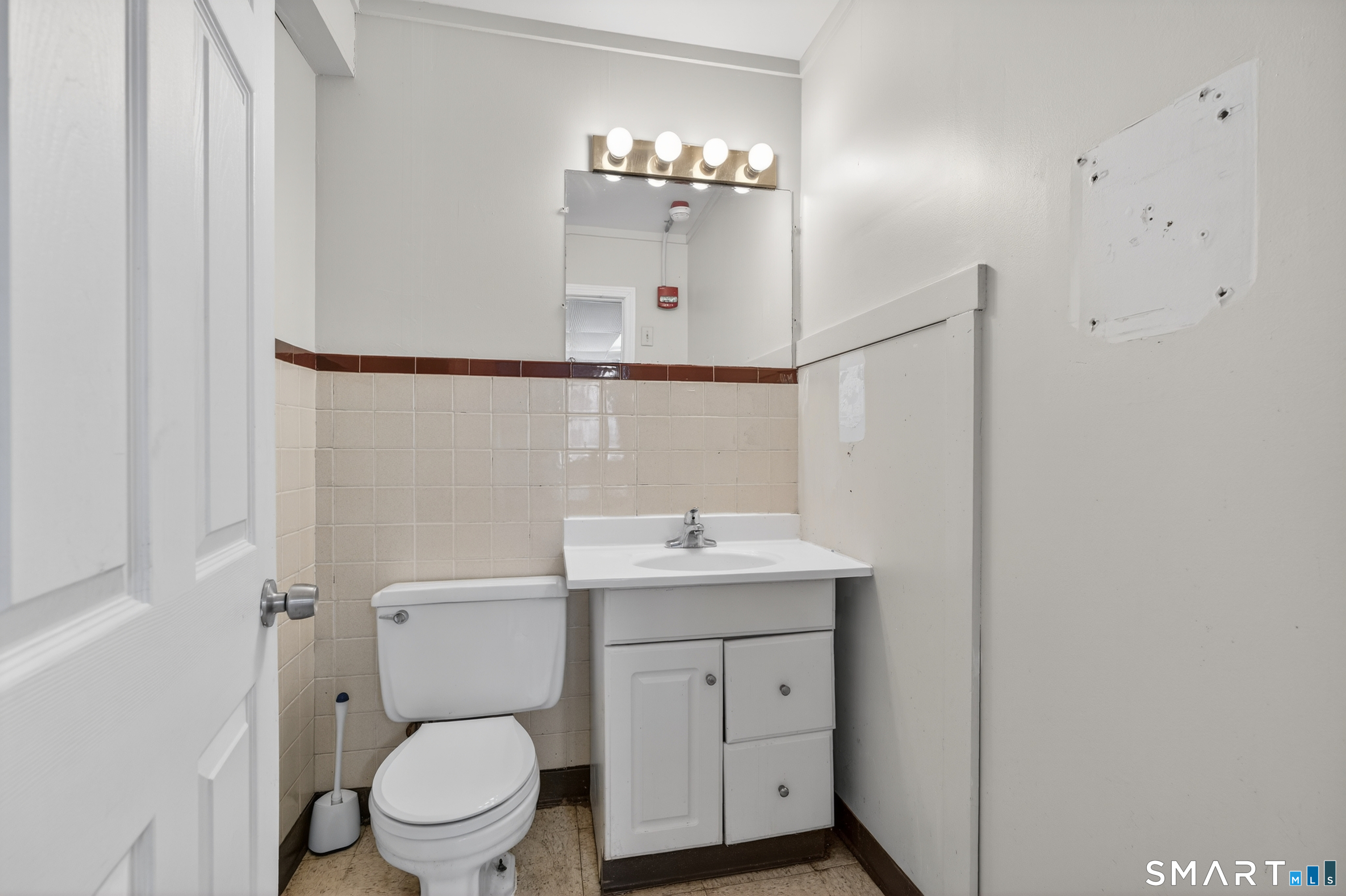 1553 Glasgo Road Griswold, CT 06351 - Photo 32 of 37 a bathroom with a toilet a sink and mirror