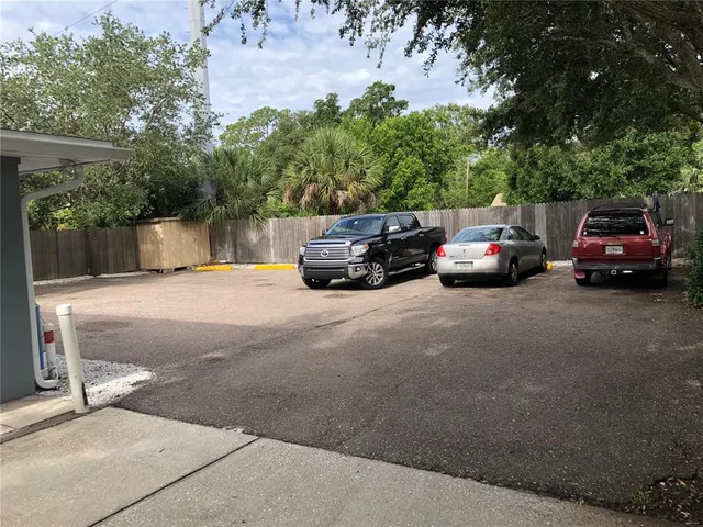 a view of backyard with tub and trees in the background