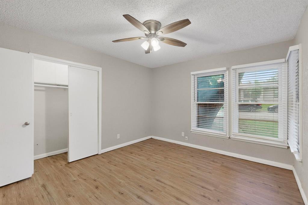 4508 Rutland Avenue Fort Worth, TX 76133 - Photo 20 of 36 a view of an empty room with wooden floor and a window