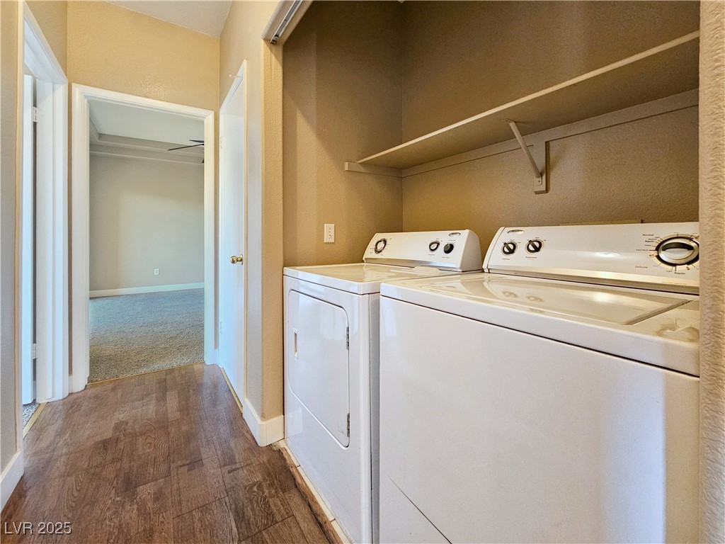 1851 Hillpointe Road, Unit 2124 Henderson, NV 89074 - Photo 23 of 24 Laundry area with washer and dryer, laundry area, dark wood-type flooring, and baseboards