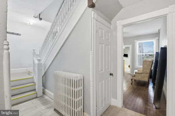 a view of a hallway view with wooden floor and staircase