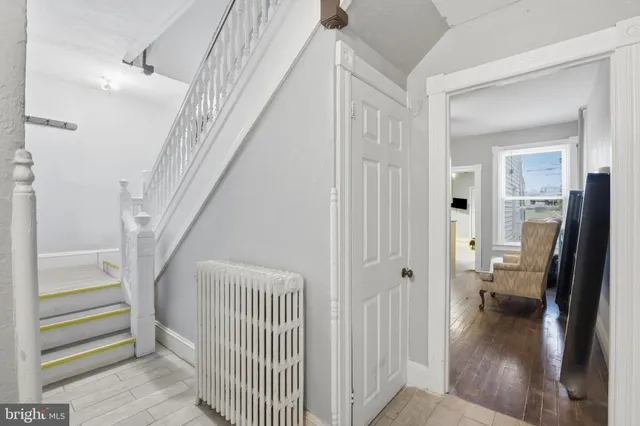 a view of a hallway view with wooden floor and staircase