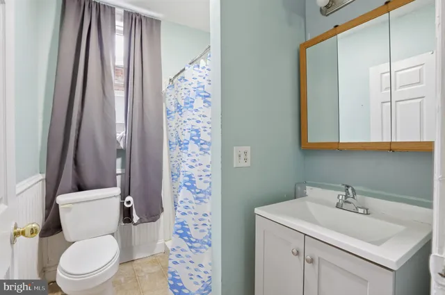 a white toilet sitting next to a bathroom sink