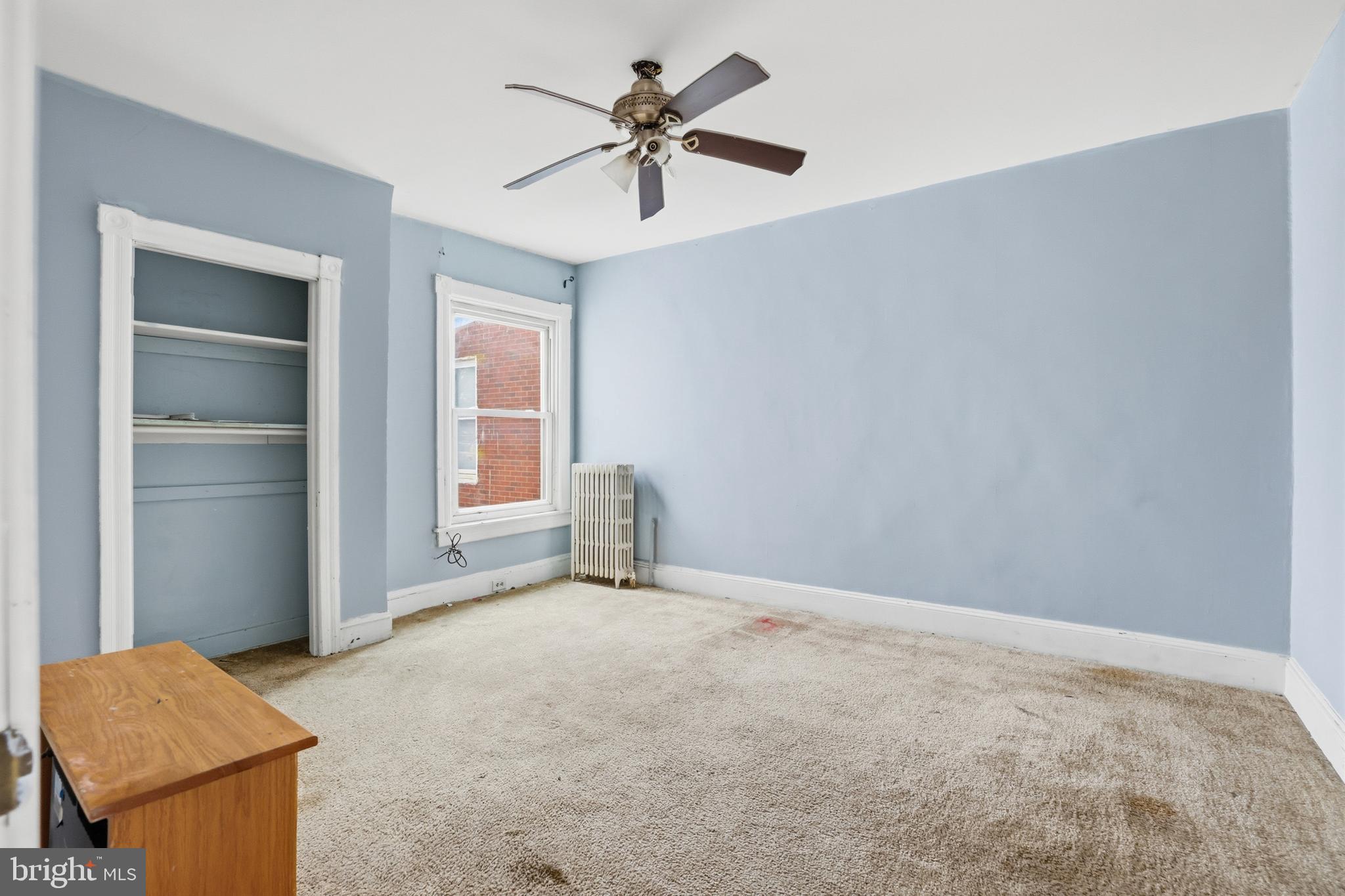 100 West Main Street Westminster, MD 21157 - Photo 22 of 26 a view of an empty room with a ceiling fan and a window