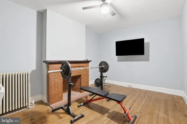 a view of a workspace with furniture and a flat screen tv