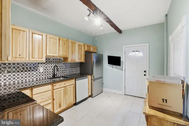 a kitchen with stainless steel appliances a sink and a refrigerator