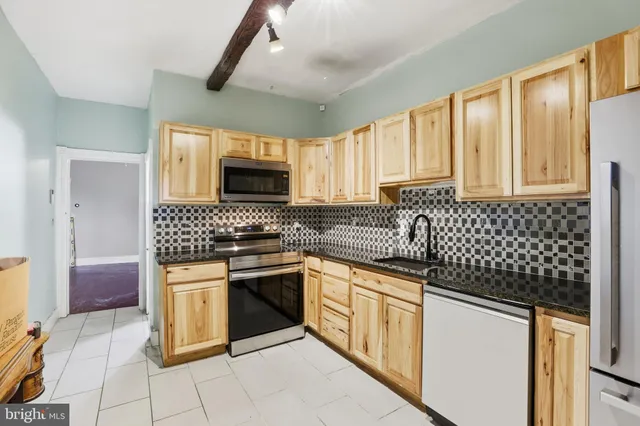 a kitchen with a sink stove and microwave