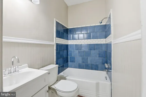a bathroom with a toilet a sink and bathtub