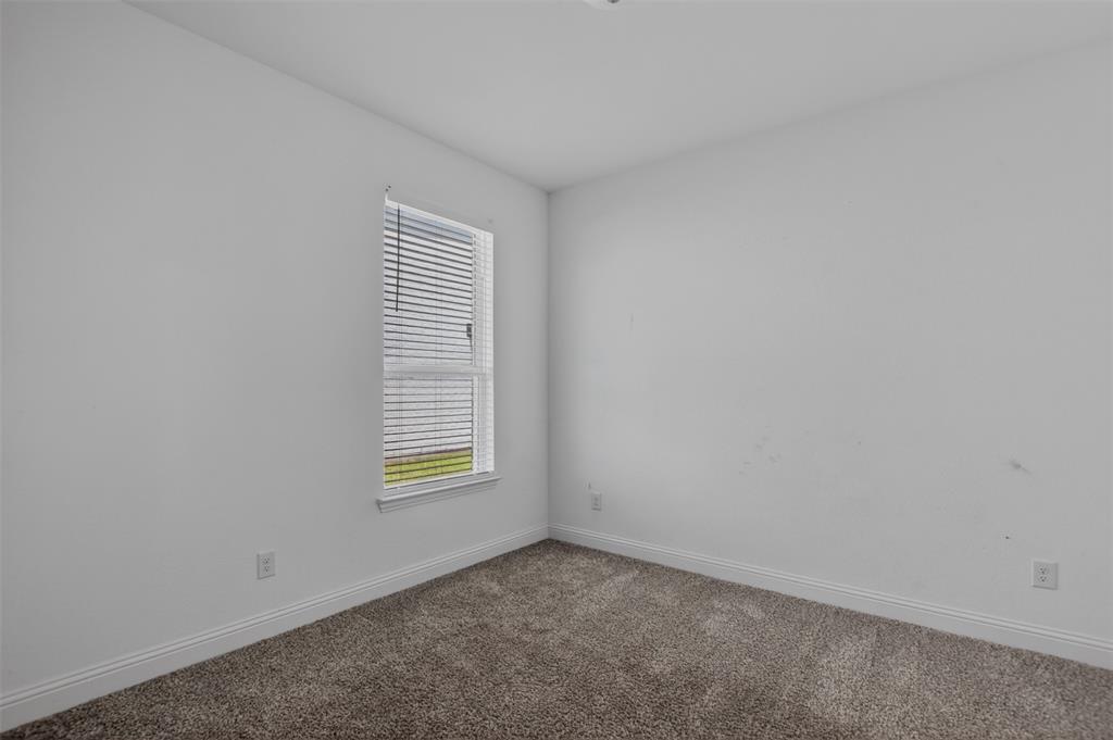 845 Ranchland Road Justin, TX 76247 - Photo 8 of 22 an empty room with windows