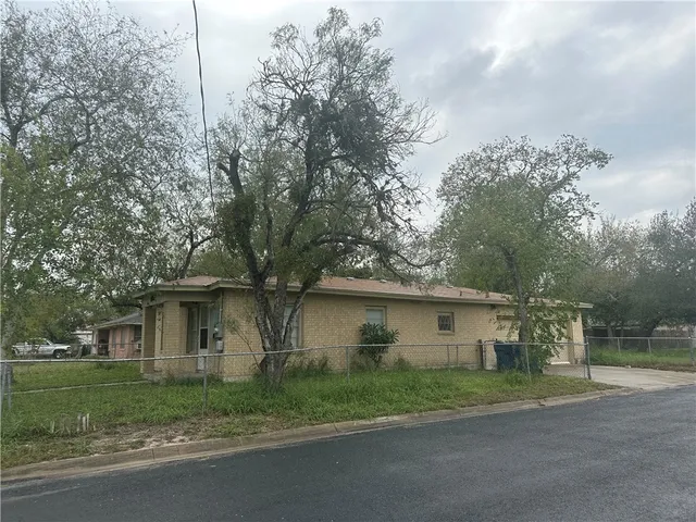 a front view of a house with a yard and a garage