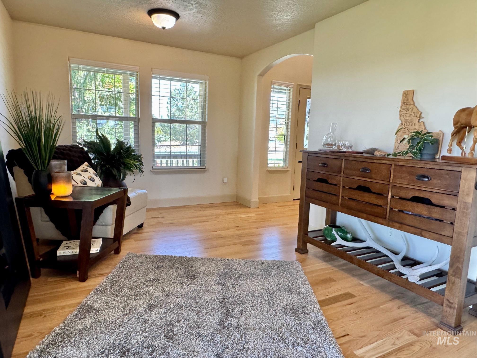 9299 Kemp Road Middleton, ID 83644 - Photo 19 of 50 Bright interior with natural wood flooring and an arched doorway