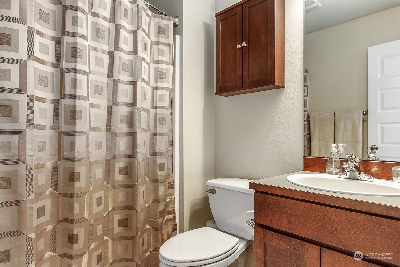 18316 35th Drive Southeast Bothell, WA 98012 - Photo 21 of 26 a bathroom with a sink a toilet and shower curtain
