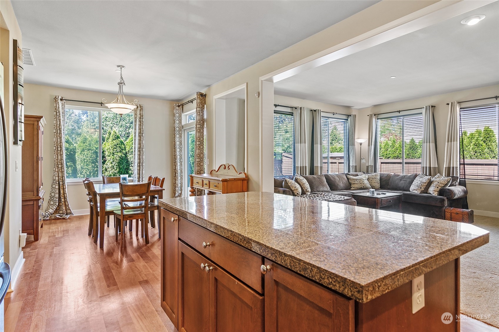 18316 35th Drive Southeast Bothell, WA 98012 - Photo 3 of 26 a dining hall with couches a coffee table and chairs with wooden floor