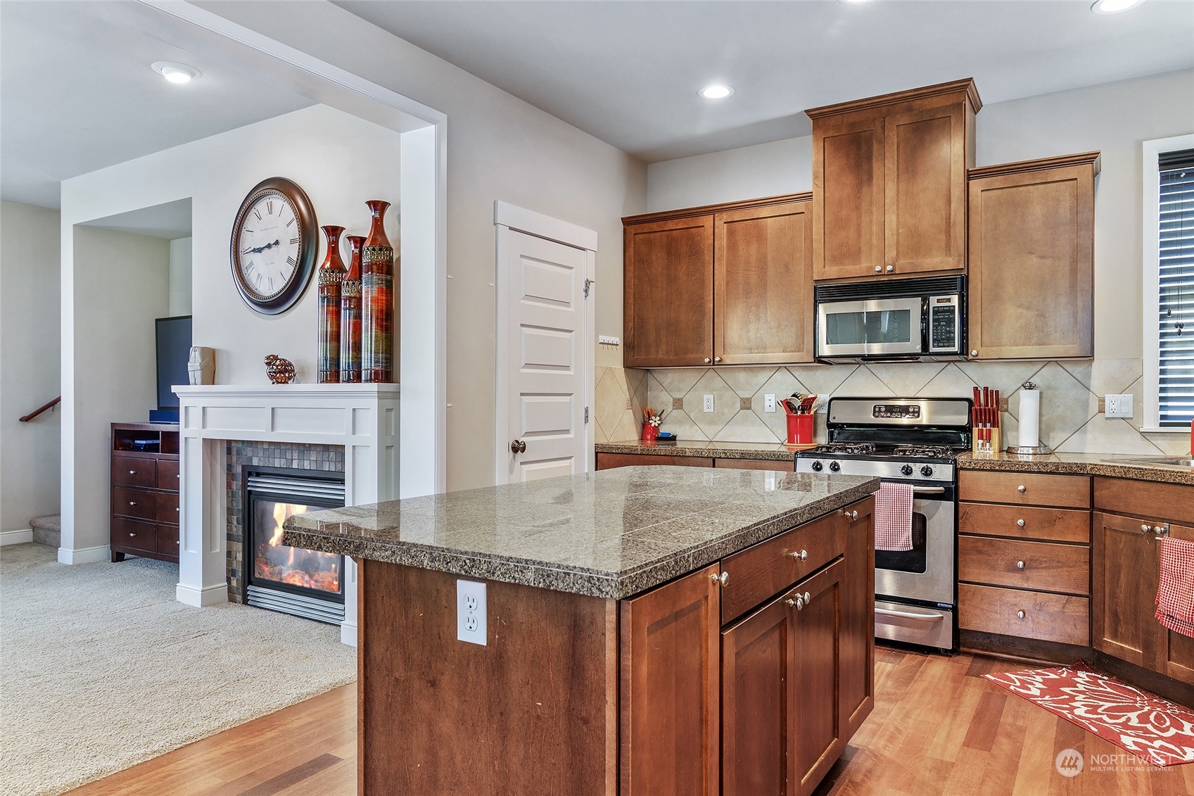 18316 35th Drive Southeast Bothell, WA 98012 - Photo 4 of 26 a kitchen with stainless steel appliances granite countertop a stove a sink and a refrigerator