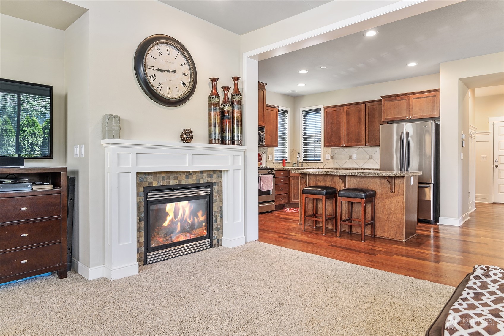 18316 35th Drive Southeast Bothell, WA 98012 - Photo 9 of 26 a living room with furniture a clock and a fireplace