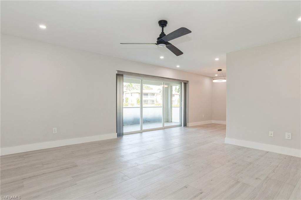 1155 Sandpiper Street, Unit B3 Naples, FL 34102 - Photo 3 of 21 Empty room with a ceiling fan, light wood-style floors, and recessed lighting
