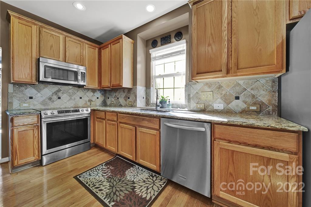 1640 Spandril Lane Fort Mill, SC 29708 - Photo 16 of 48 a kitchen with stainless steel appliances granite countertop a stove a sink and a microwave