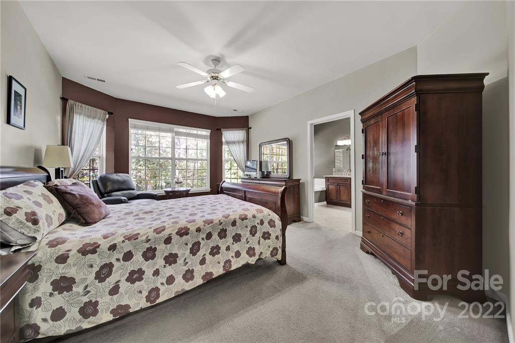 1640 Spandril Lane Fort Mill, SC 29708 - Photo 19 of 48 a bedroom with a large bed and a chandelier