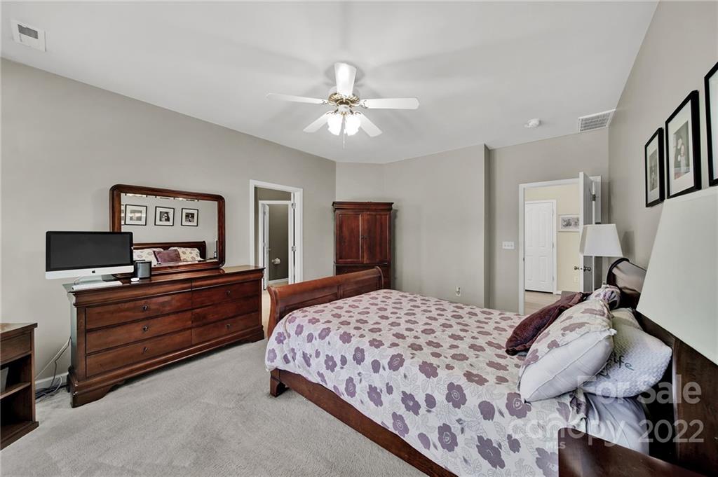 1640 Spandril Lane Fort Mill, SC 29708 - Photo 20 of 48 a bedroom with a bed and a chandelier