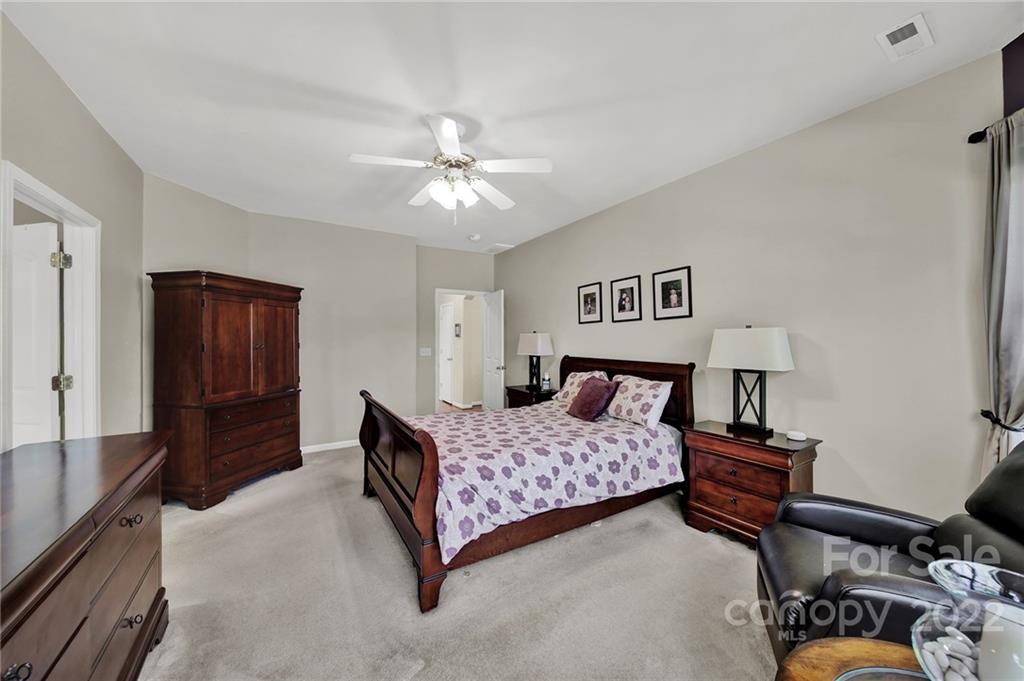 1640 Spandril Lane Fort Mill, SC 29708 - Photo 21 of 48 a bedroom with a bed and a chandelier