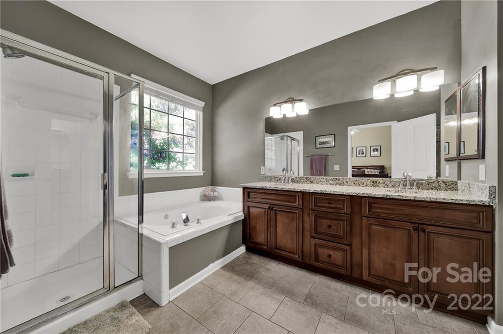 1640 Spandril Lane Fort Mill, SC 29708 - Photo 22 of 48 a spacious bathroom with a tub a double vanity sink and a mirror