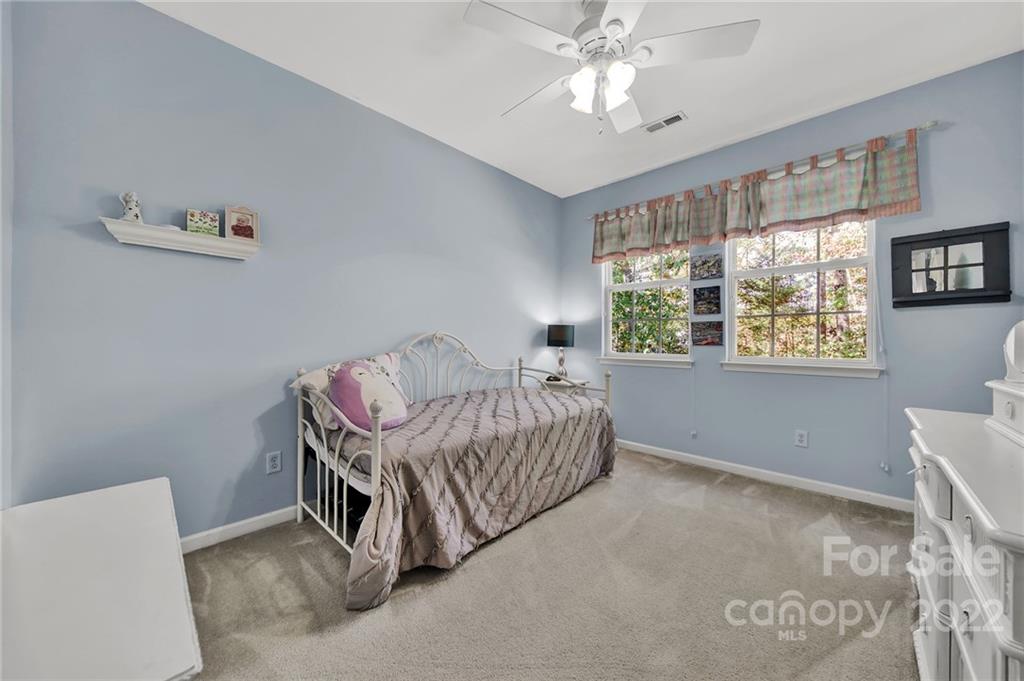 1640 Spandril Lane Fort Mill, SC 29708 - Photo 23 of 48 a bedroom with a bed and a chandelier