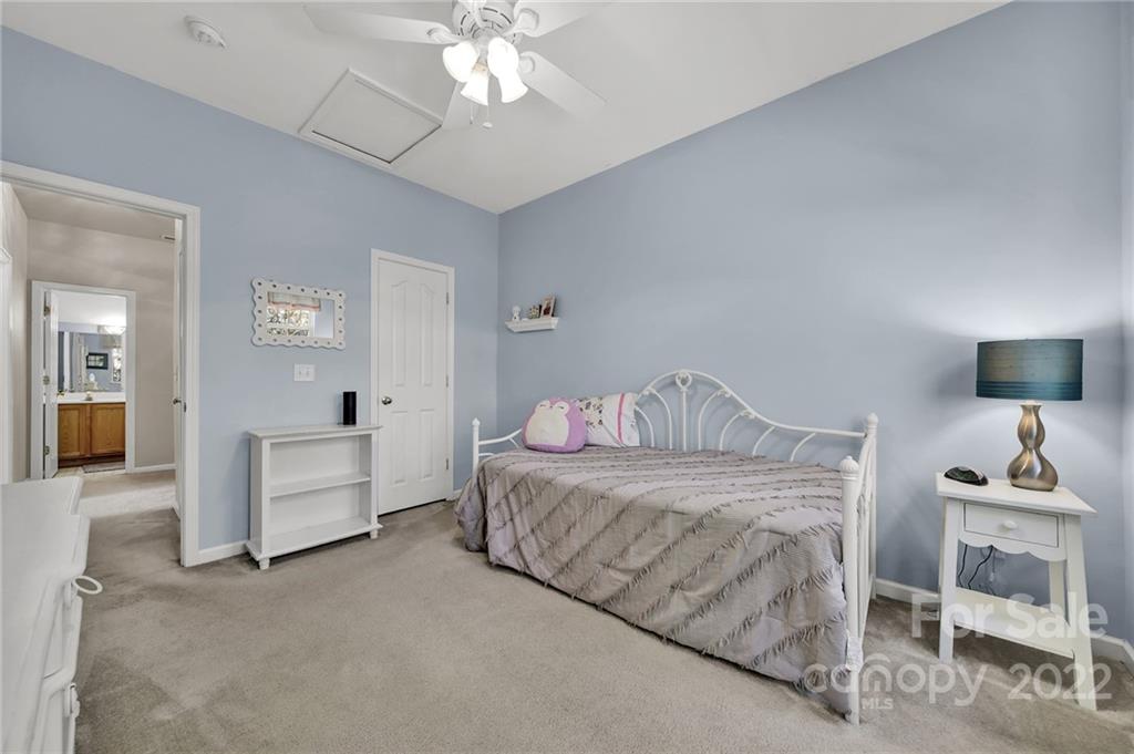 1640 Spandril Lane Fort Mill, SC 29708 - Photo 24 of 48 a bedroom with a bed and a chandelier