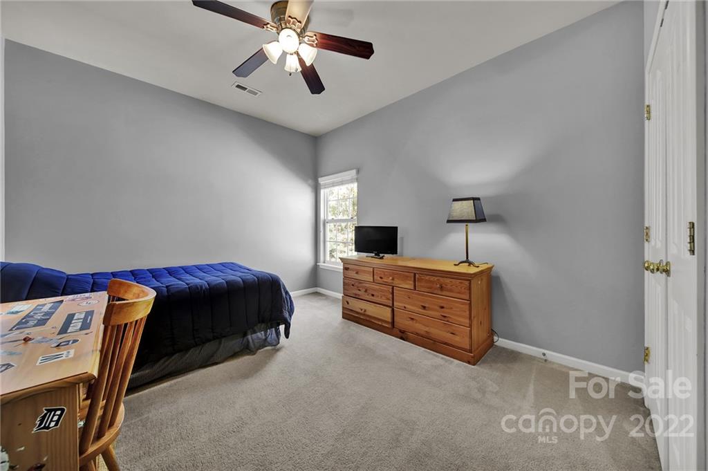 1640 Spandril Lane Fort Mill, SC 29708 - Photo 25 of 48 a bedroom with a bed and a chandelier