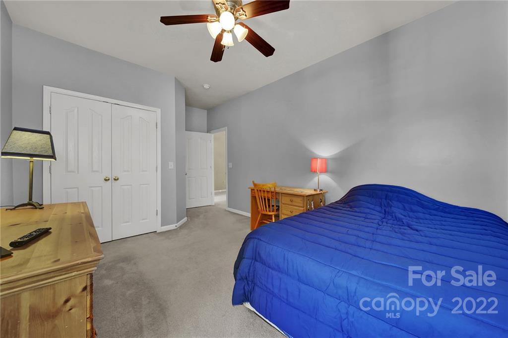 1640 Spandril Lane Fort Mill, SC 29708 - Photo 26 of 48 a bedroom with a bed and a chandelier
