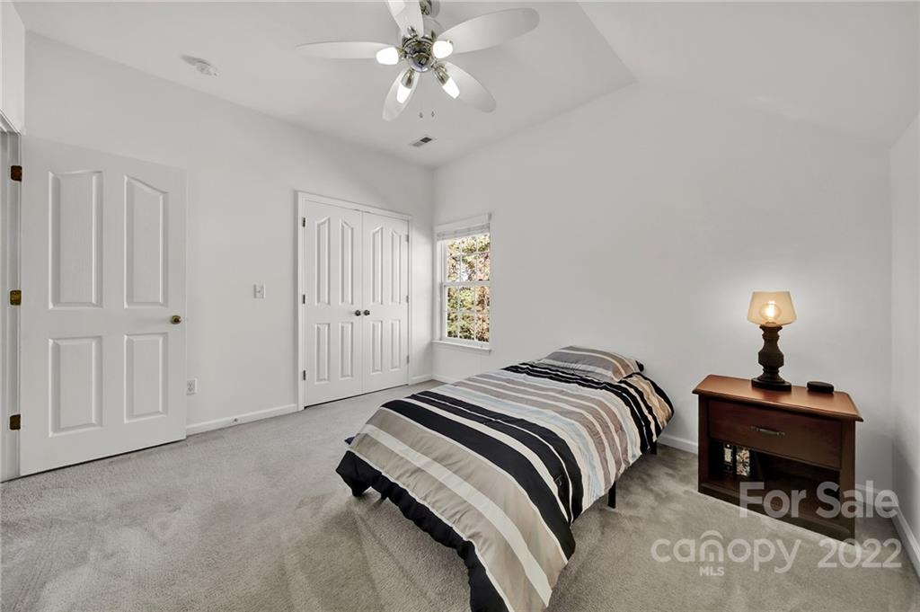 1640 Spandril Lane Fort Mill, SC 29708 - Photo 28 of 48 a bedroom with a bed and a chandelier