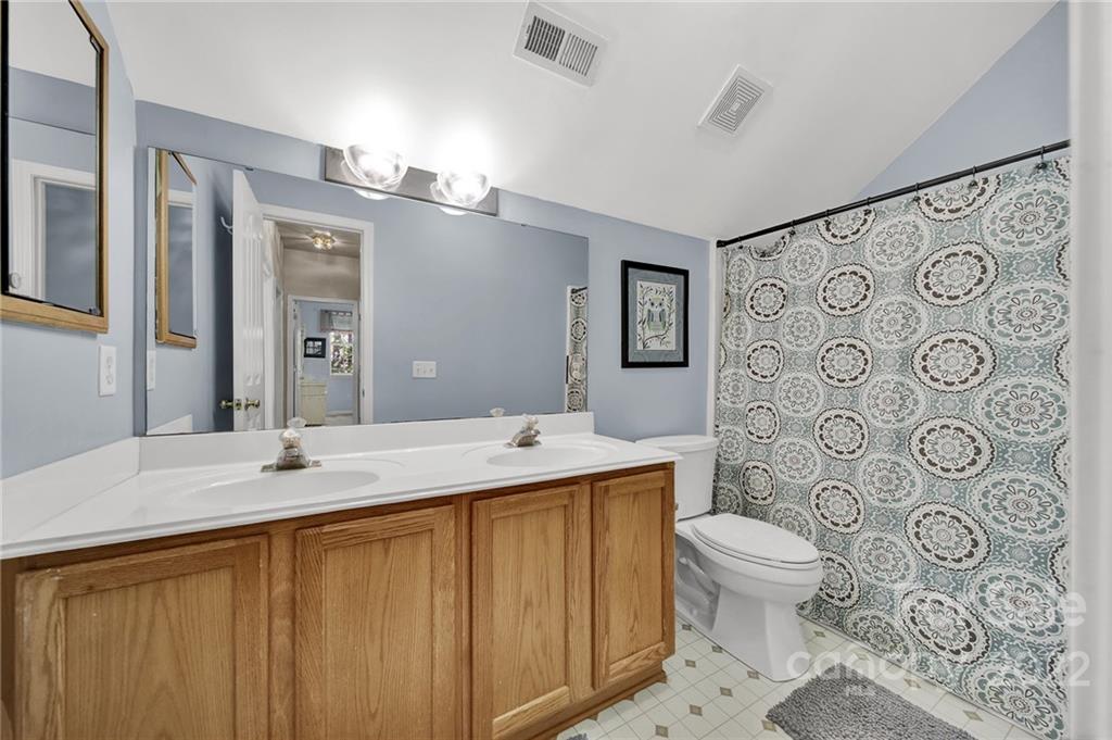1640 Spandril Lane Fort Mill, SC 29708 - Photo 29 of 48 a bathroom with a granite countertop toilet sink and mirror