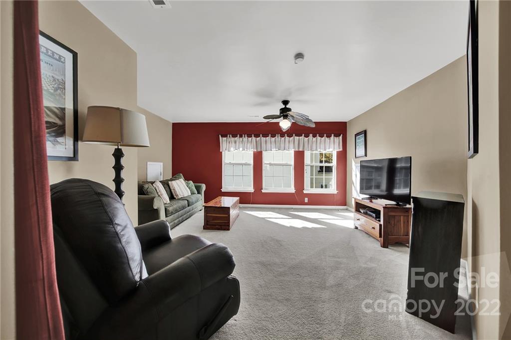1640 Spandril Lane Fort Mill, SC 29708 - Photo 31 of 48 a living room with furniture a flat screen tv and a fireplace