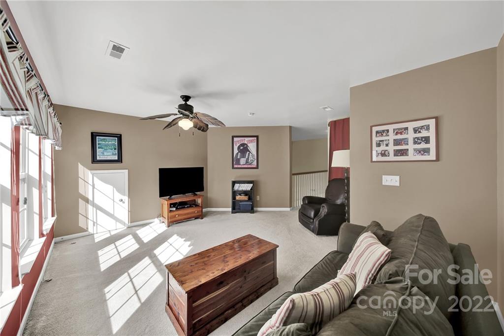 1640 Spandril Lane Fort Mill, SC 29708 - Photo 32 of 48 a bedroom with furniture or couch and a fireplace