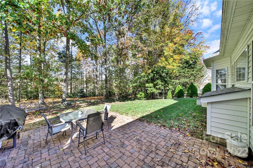1640 Spandril Lane Fort Mill, SC 29708 - Photo 35 of 48 a view of a backyard with table and chairs and a yard