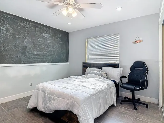 a bedroom with a bed and chair