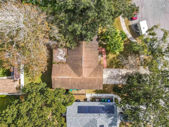 a aerial view of a house with a yard and tree s