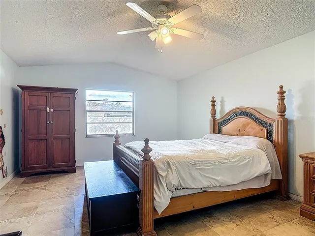 a bedroom with a bed window and dresser