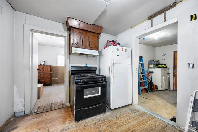 a kitchen with a refrigerator and a stove