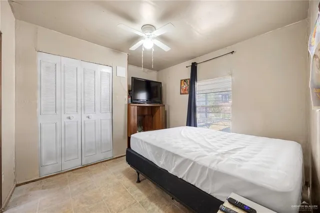 a bedroom with a bed and a television