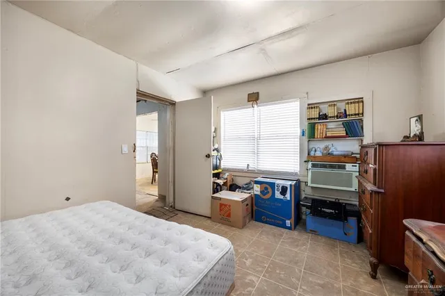 a bedroom with furniture and a window
