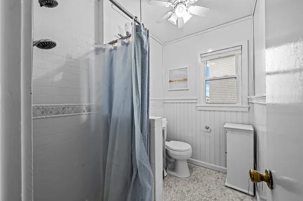 a bathroom with a shower a toilet and a sink