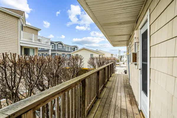 a view of balcony with wooden floor and fence