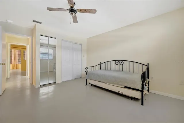 a view of a bedroom with wooden floor