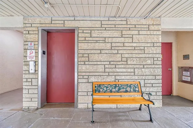 a outdoor view with a bench and potted plant